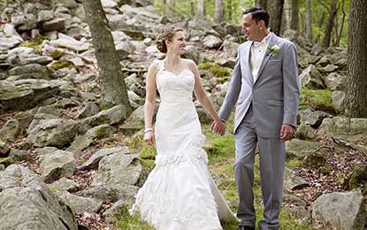 A newlywed couple strolling in the forest